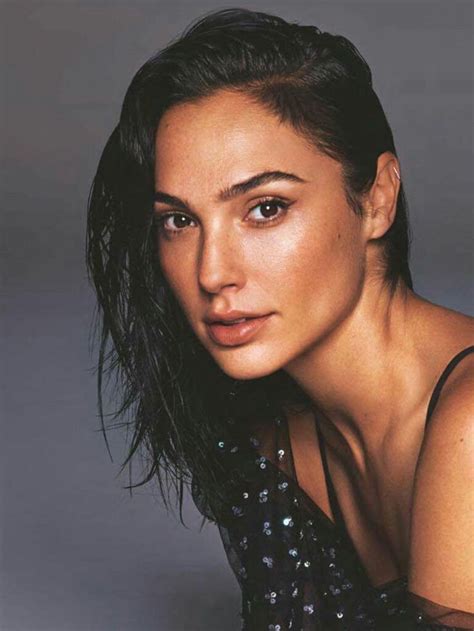 a close up of a person wearing a black dress and posing for a photo ...