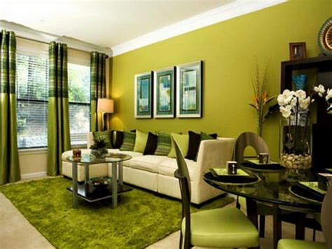 a living room filled with furniture and green walls