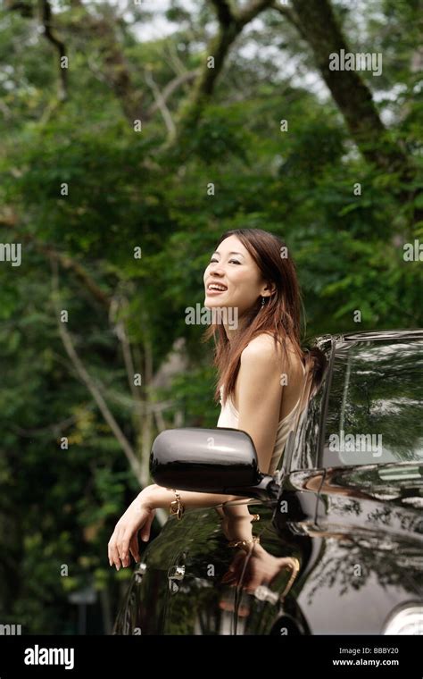 Woman hanging out car window Stock Photo - Alamy