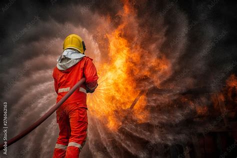 firefighters spraying water in fire fighting operation, Fire and rescue ...