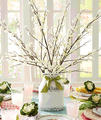 white flower table decor with paper bunnies hanging from it | Easter table decorations, Spring ...