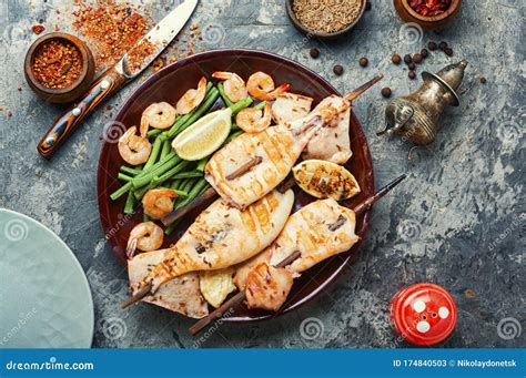 Grilled squid on a skewer stock image. Image of lime - 174840503