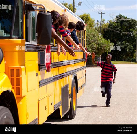 Student Running To Catch The School Bus Stock Photo - Alamy