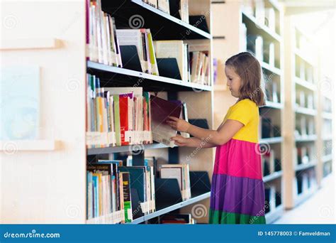 Child in School Library. Kids Reading Books Stock Image - Image of choose, paper: 145778003