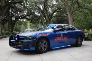 a police car parked in front of some trees