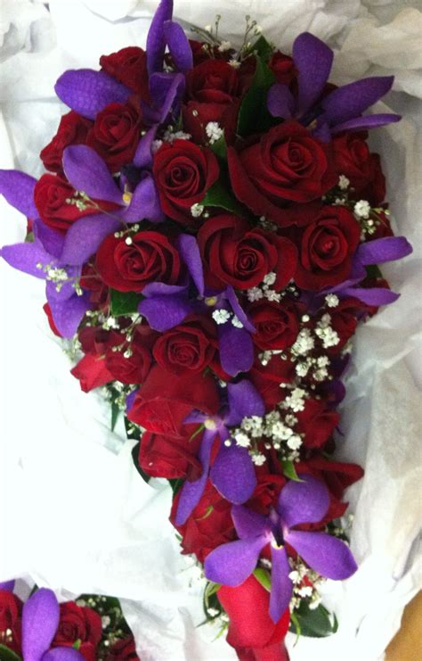 Teardrop bouquet of red roses, purple lisianthus and babies breath in ...