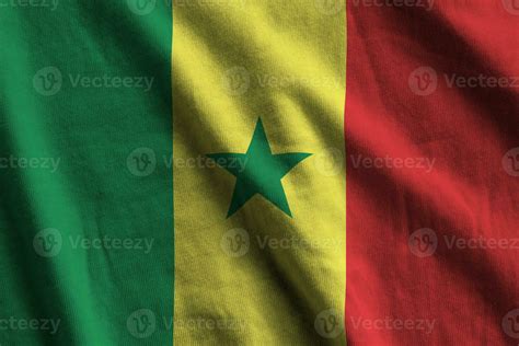Senegal flag with big folds waving close up under the studio light indoors. The official symbols ...