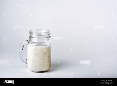 Protein cocktail with milk, vanilla in a glass jar with straws. Sports nutrition Stock Photo - Alamy