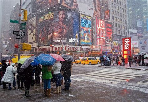 "Times Square Snow" A busy Times square with people during a snow storm ...