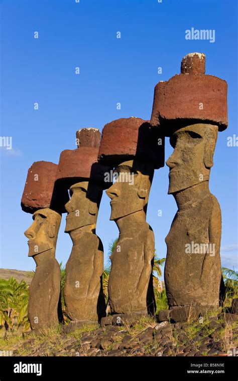 Anakena beach, monolithic giant stone Moai statues of Ahu Nau Nau, four of which have topknots ...