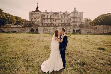 Free Photo | Just-married couple with old castle in the distance