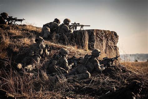 US Army Ranger weapons squad and sniper team establish support-by-fire ...