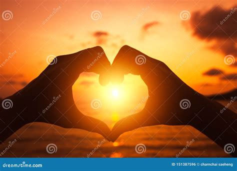 Hands Forming a Heart Shape with Sunset Silhouette Stock Photo - Image of female, outdoor: 151387596