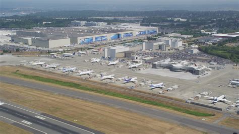 5K stock footage aerial video of Boeing Everett Factory and rows of airliners at Paine Field ...