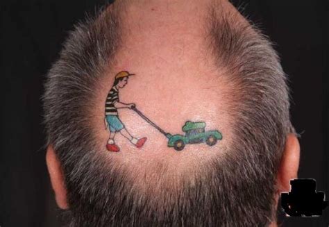 a man with a tattoo on his head is pulling a lawnmower behind his head