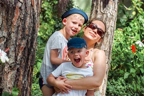 Mother and Little Boys Stand among Pines in Hotel Park Stock Photo - Image of caucasian, fresh ...