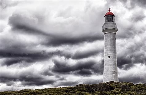 Beacon in the Storm | Lighthouse, Storm, Castle