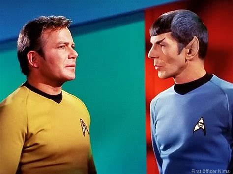 two men in star trek uniforms standing next to each other