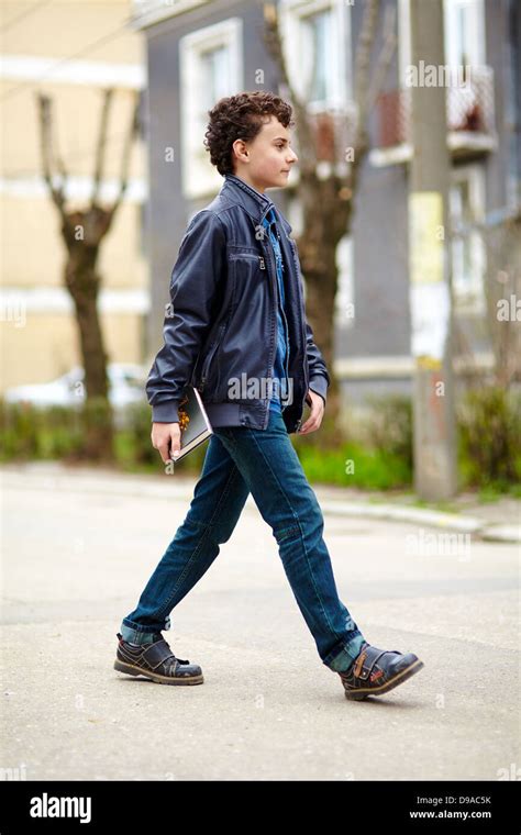 School boy walking alone hi-res stock photography and images - Alamy