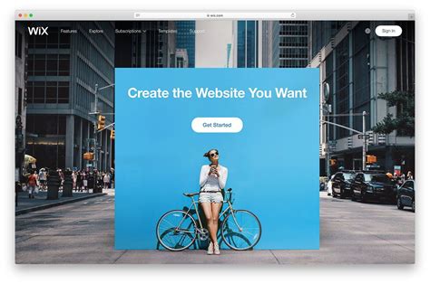 a woman standing in front of a blue sign that says create the website you want