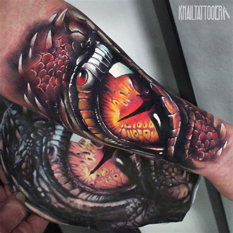 Realistic dragon eye tattoo on the inner forearm.