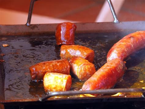 Premium Photo | Grilling sausages on a barbecue grill