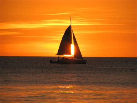 Sailboat Photography | sailboat sails in front of the sunset off Coquina Beach on southern ...