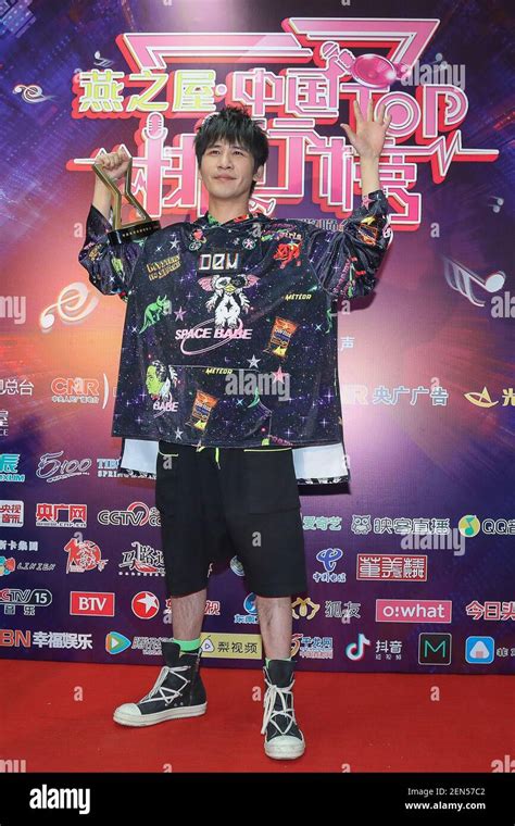 Chinese singer and actor Wowkie Zhang, also known as Da Zhang Wei, poses with his trophy after ...