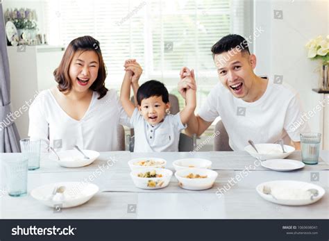 Happy Asian Family Raising Childs Hands Stock Photo 1069698041 ...