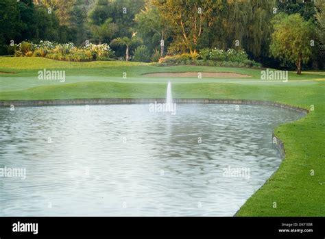 Golf Green with Water Hazard Stock Photo - Alamy