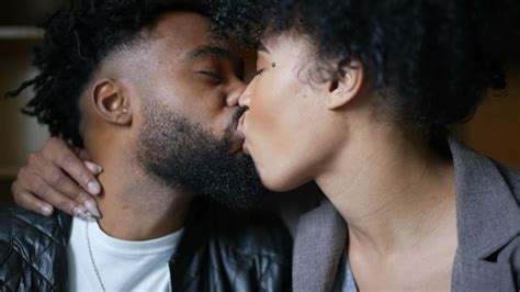 Premium Photo | A young black couple kissing passionately