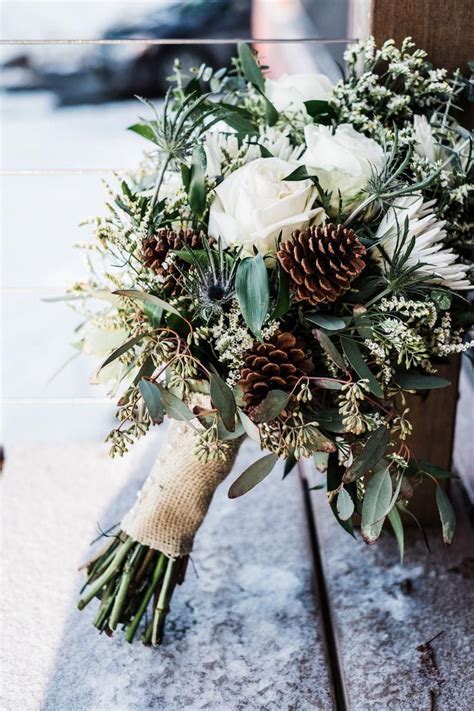 rustic winter wedding bouquet with white roses, eucalyptus and pine cones | Winter wedding ...