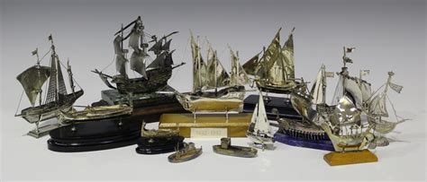 A group of thirteen silver and plated models of sailing ships and boats ...