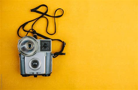 "Vintage Camera On A Yellow Background." by Stocksy Contributor "Kkgas" - Stocksy