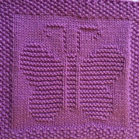 a purple knitted blanket with the letter e on it's front and bottom