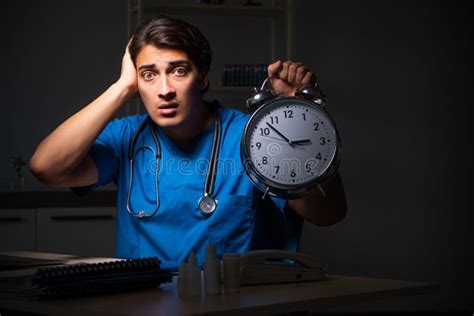 The Young Handsome Doctor Working Night Shift in Hospital Stock Image - Image of evening ...