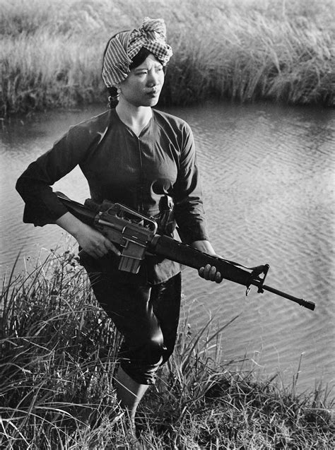 Female Vietcong guerilla fighter carrying a m-16 rifle during the ...