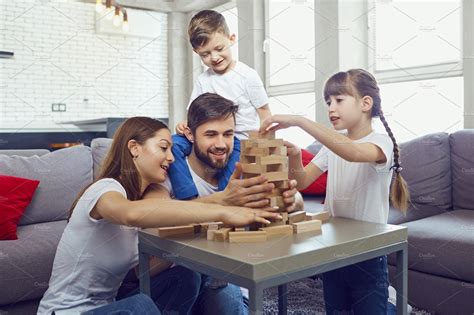 Happy family playing board games at home stock photo containing family ...