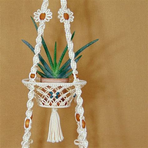 This macrame hanging table holder with basket is a unique and fun accent piece ideal for a kitch ...