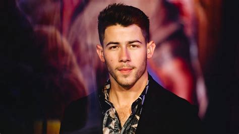 Download Nick Jonas With Colorful Lights Wallpaper | Wallpapers.com