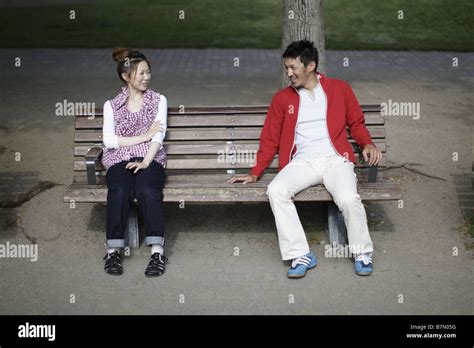 Couple Sitting on Bench Stock Photo - Alamy