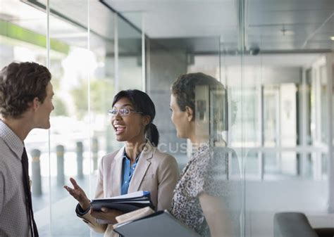 Business people talking at modern office — man, reflection - Stock Photo | #199737176