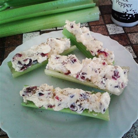 Celery sticks stuffed with cream cheese, onion and cranbrerries. Topped with salt and pepper ...