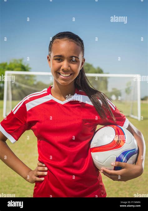 Mixed race soccer player standing on field Stock Photo - Alamy
