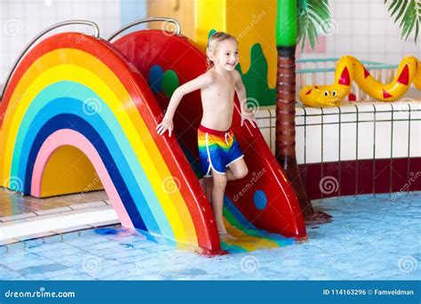 Child on Swimming Pool Slide. Kids Swim. Water Fun Stock Photo - Image ...