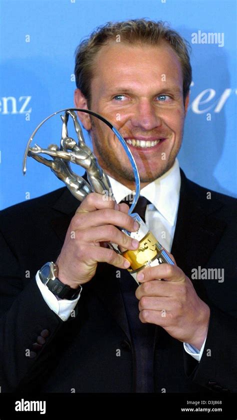 (dpa) - Austrian skier Hermann Maier smiles as he poses with the Laureus Award in his hand which ...