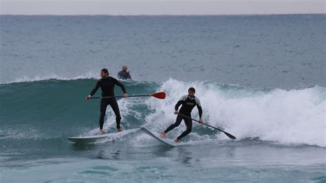 Winter surfing on the beach of San Sebastian (Platja de Sant Sebastià)