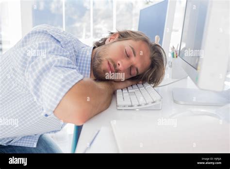 Man sleeping on his desk in bright modern office Stock Photo - Alamy