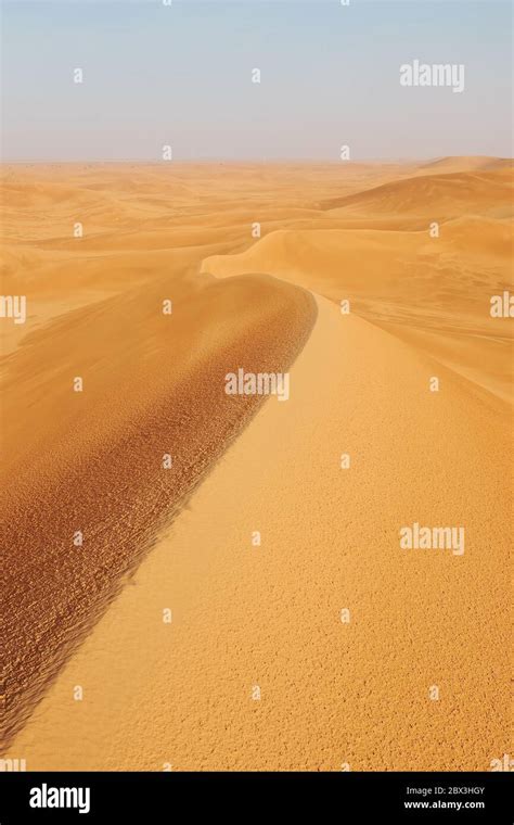 Portrait shot of bright orange desert landscape sand dunes in Al Dahna Desert, Riyadh, Saudi ...