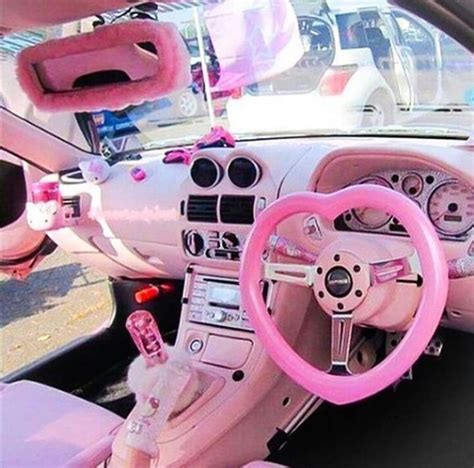 the interior of a pink car with steering wheel and dash light ...